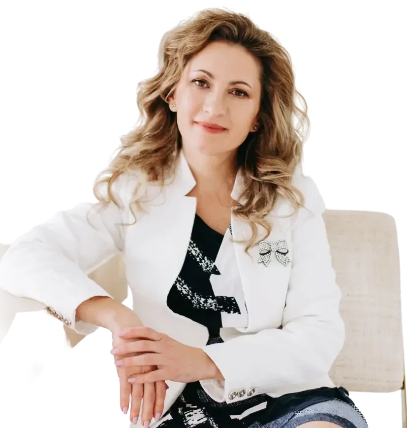 Carolina Vintu, PhD, Registered Psychotherapist, seated in a white blazer